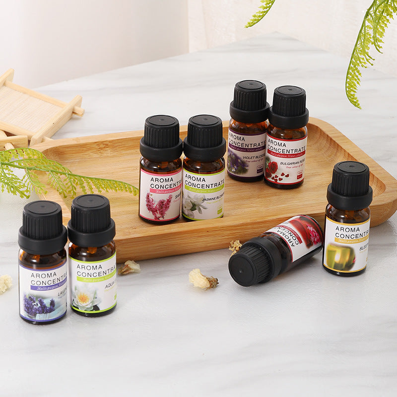 LUMORA 10ML Aroma Humidifier Essential Oils displayed on a wooden tray with greenery.